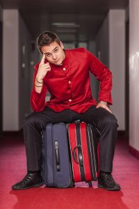 Tired Bellboy with Luggages